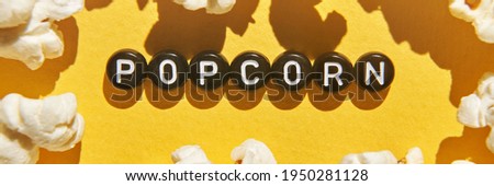 Popcorn quote design. Typography concept. Creative text wallpaper. Phrase yellow background. Cinema food concept. Film delicious snack. Black round letters