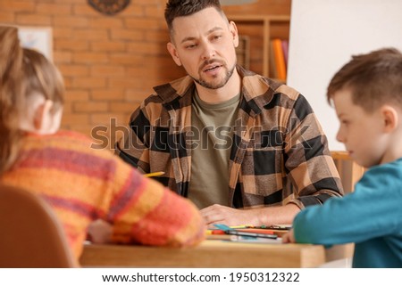 Drawing teacher giving optional classes at school