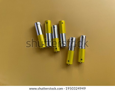 Alkaline batteries AAA size on colored background Royalty-Free Stock Photo #1950324949