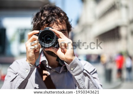 Close-up of a photographer using his camera Royalty-Free Stock Photo #1950343621
