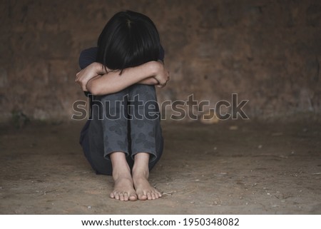 Sad child sitting in old room, Trafficking in human beings Royalty-Free Stock Photo #1950348082