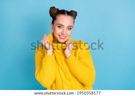 Photo of pretty satisfied young girl hands touch pullover collar look camera isolated on blue color background