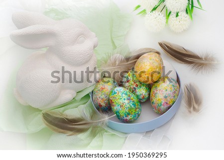 Easter eggs and a rabbit on a white background .