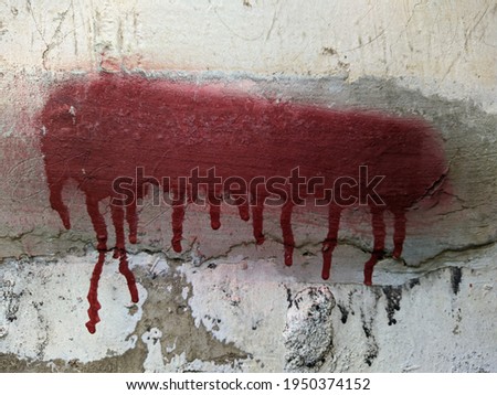red paint on the wall flows down