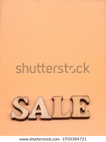 Discount sale. Large letters sale, action. Wooden letters discount on orange background.