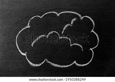 White color chalk hand drawing in cloud shape on blackboard or chalkboard background