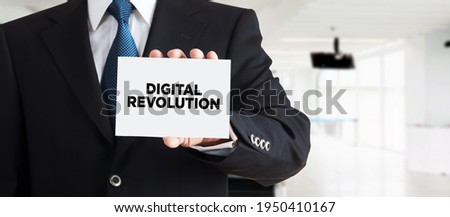 Businessman shows a business card with the message digital revolution. Digital revolution in business industry concept.

