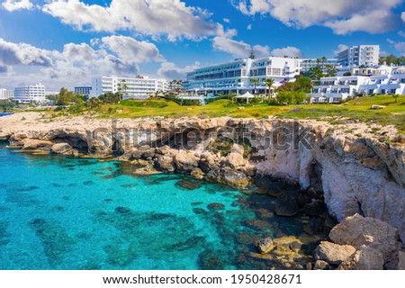 Landscape of Cyprus coast. Ayia Napa resort hotels. Hotel building near obrava. Cyprus panorama on a blue sky background. Tourism to Republic of Cyprus. Holidays at Ayia Napa Resort. Royalty-Free Stock Photo #1950428671