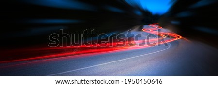 Panoramic - Cars light trails at night in a curve  asphalt road at night, long exposure image Royalty-Free Stock Photo #1950450646