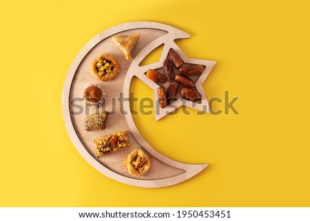 Assortment of Ramadan dessert baklava on yellow background Royalty-Free Stock Photo #1950453451