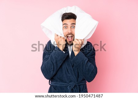 Young man going to sleep isolated on pink background
