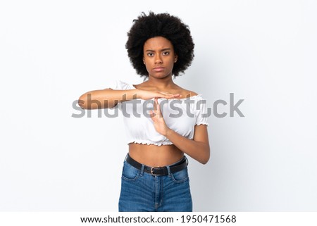 Young African American woman isolated on white background making time out gesture