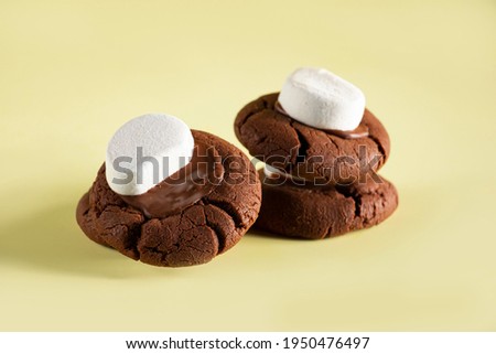 Cloud Dark Cookies with chocolate and candy in the top on yellow background 