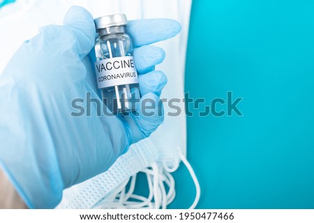 donation coronavirus vaccine, covid-19 vaccination for disease immunity, Doctor's hands in gloves hold an ampoule with drug on a medical blue background in a clinic
