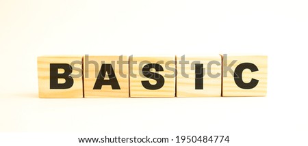 The word BASIC. Wooden cubes with letters isolated on white background. Conceptual image.