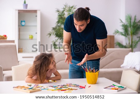 Young father and little girl indoors