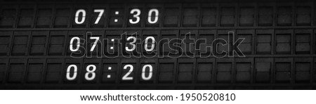 Time boards at the airport. Flight information mechanical timetable. Split flap mechanical departures board. Flight schedule.
