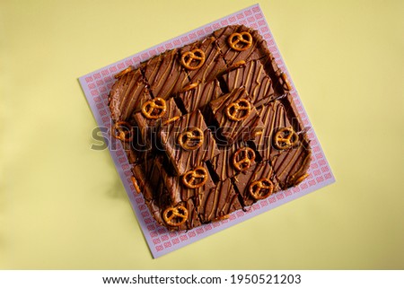 Monopoly Chocolate Cake and black coffee on yellow background 