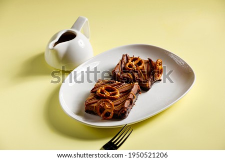 Monopoly Chocolate Cake and black coffee on yellow background 
