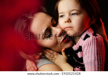 Hugs of mother and daughter. Happy mom hugs daughter. Baby hugs. A trusting relationship between mother and child. A touching moment for children and parents. The daughter hugs her mother. Mothers Day
