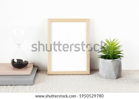 Small wooden photo frame mockup with books