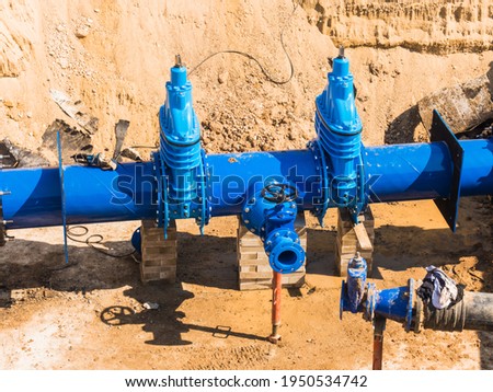 Replacement of water pipes networks.  Waterworks main pipeline for the supply of drinking water to the desert city. Royalty-Free Stock Photo #1950534742