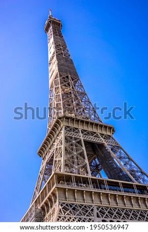 Eifeltower seen from below under a slight angle and with a blue sky Royalty-Free Stock Photo #1950536947
