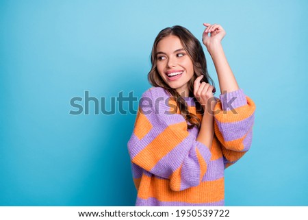 Photo of funky happy young lady dance stand look empty space smile isolated on pastel blue color background