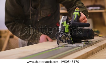 Woodwork and furniture making. Joinery, woodworking and furniture making, professional carpenter cutting wood in carpentry shop, industrial concept