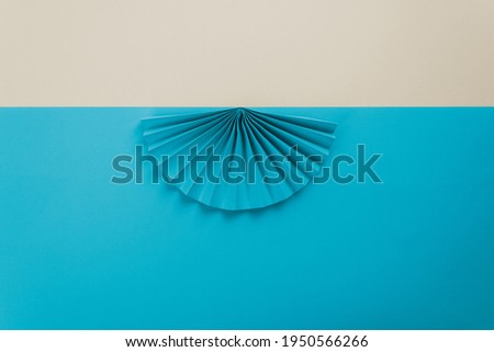 Blue origami flowers. Geometric shapes and lines. Minimalist background. Flat lay. Copy space.  
