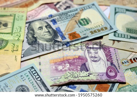 American 100 dollars banknotes and Saudi Arabia riyals currency banknotes, Saudi Arabia money and American dollars currencies exchange rate