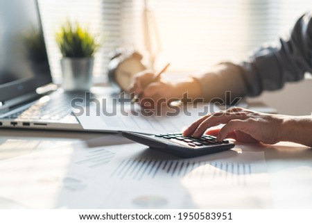 Tax deduction planning concept. Businessman calculating business balance prepare tax reduction. Royalty-Free Stock Photo #1950583951