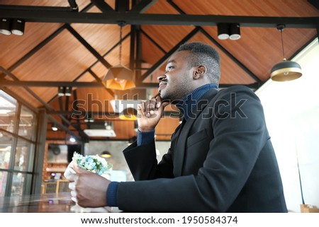 African businessman having a happy time with good idea thinking in cafe