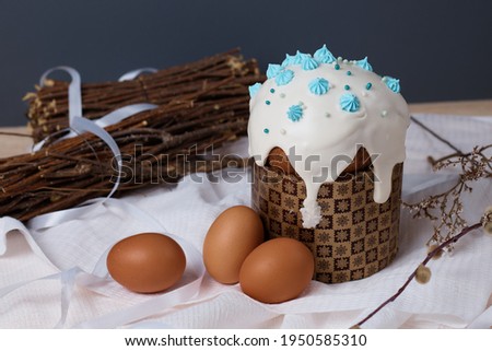 traditional Christian holiday, Easter cakes and eggs on the table dry plants, willow