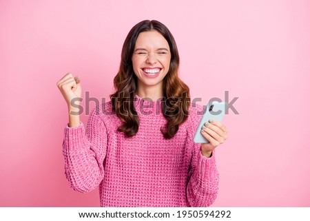 Photo of hooray nice brunette lady hold telephone wear pink sweater isolated on pastel pink color background