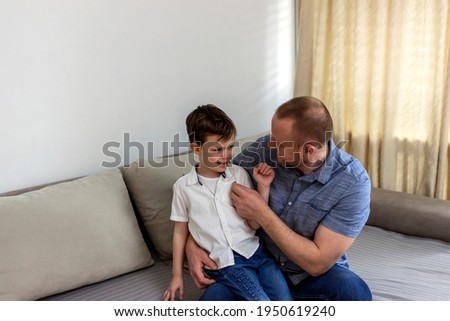 Father taking a cotton swab coronavirus test from child nose to analyse if positive for covid-19. Caucasian dad is taking a sample with a swab for corona virus test from a little Caucasian boy's nose.