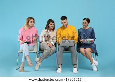 People waiting for job interview on light blue background