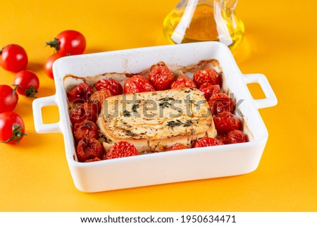 Viral Feta bake pasta recipe with roasted cherry tomatoes, cheese, herbs and garlic isolated on a colored background with space for text