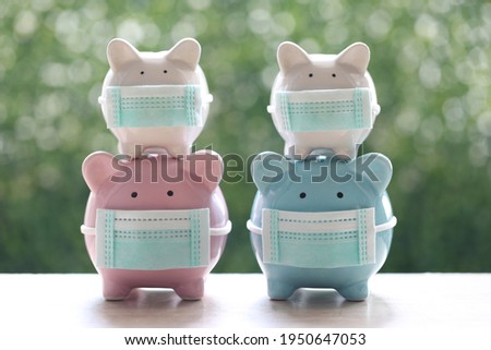 Piggy with wearing protective medical mask with stethoscope on natural green background, Save money for Medical insurance and Health care concept
