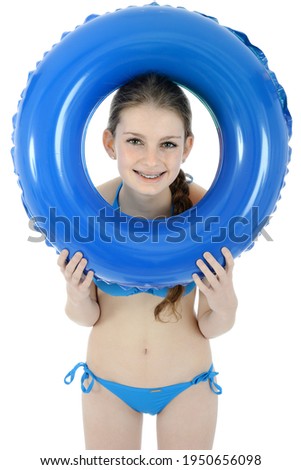 Beautiful teenager with swim ring in studio isolated on white