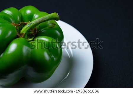 Paprika in bowl with colored background
