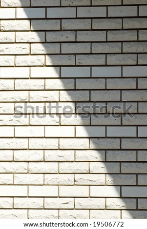 White brick wall with a shadow, background