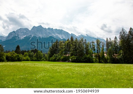 Mountain panorama in front of cloud sky scene. Mountain range wetterstein mountains, Waxenstein and Zugspitze peaks. Wetterstein range Northern Limestone Alps Bayern Germany Europe