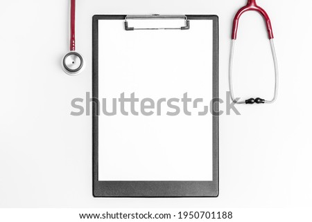 Flat lay photo of medical clipboard with stethoscope
 