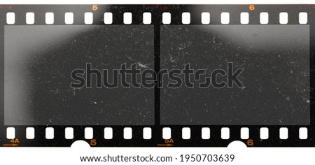 real scan of two empty or blank film frames with dust and scratches isolated on white background, 35mm film.