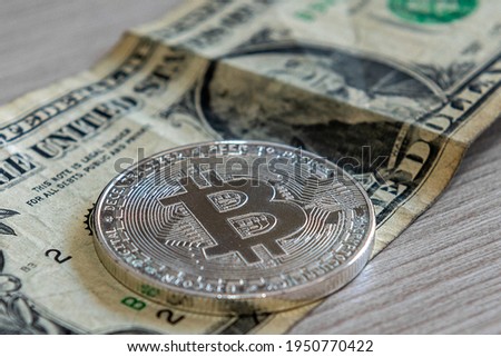 concept of a bitcoin coin on a dollar