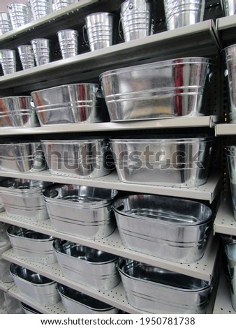 Metal galvanized buckets and containers on store shelves