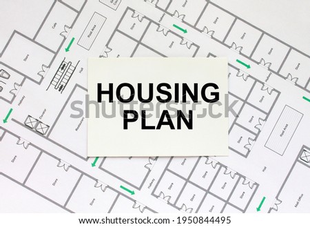 Business card with text Housing Plan on a construction drawing. Concept photo