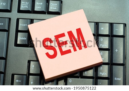 written on sticky note paper on black keyboard background. Conceptual hand writing text caption inspiration showing sem. sem - short for search engine marketing