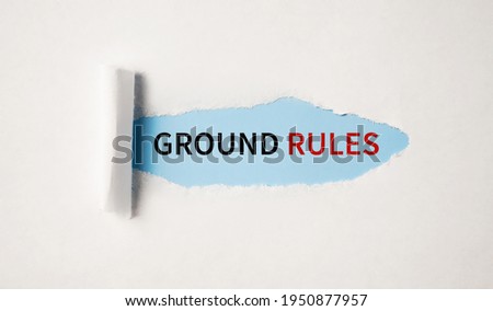 The text GROUND RULEs appearing behind torn white paper